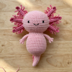 Finished pink crochet axolotl amigurumi with frilly gills