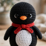 Crochet penguin pattern finished penguin with red winter scarf