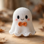 Cute crochet ghost amigurumi with orange bow tie – free crochet ghost pattern.
